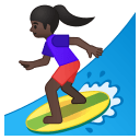 Woman surfing dark skin tone icon